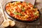 Casserole ziti pasta with minced meat, tomatoes, herbs and cheese close-up. horizontal