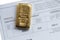 Cast gold bar weighing 250 grams on a background of a certificate