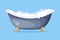 Cast Iron Bathtub on Claw Foot Pedestal Full of Water with Soap Bubbles Foam Isolated on Blue Background Vector