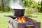 Cast iron cauldron over an open fire.