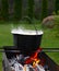 Cast iron cauldron over an open fire.