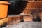 Cast-iron cauldrons stand close-up on a village oven