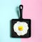 Cast-iron frying pan with fried eggs, toy duckling instead of yo