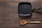 Cast iron griddle pan and turner wood on wooden background