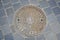 Cast iron ornamented manhole cover in Budapest, Hungary. Closeup of duct  manhole cover with Budapest Coat of Arms at the Old Town