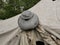 A cast-iron pot dries on the rack of a large tent on a cloudy summer day. Kitchen utensils for cooking for a large