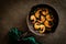 A cast iron skillet with gilled shrimp with garlic and parsley