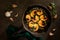 A cast iron skillet with gilled shrimp with garlic and parsley