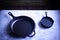 Cast iron skillets displayed on a cool grey countertop