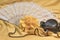 Castanets, yellow rose and white fan lying closeup