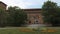 Castello Visconteo castle entrance with flowerbed in Pavia, PV, Italy