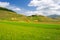 Castelluccio di Norcia highlands, Italy, blooming cultivated fields, tourist famous colourful flowering plain in the Apennines.