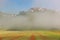 Castelluccio with poppy fields in morning Fog, Umbria, Italy