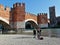 Castelvecchio bridge on the Adige river seen from close up from the walk along the river with passing tourists.