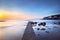 Castiglioncello bay concrete pier, rocks and sea on sunset. Tusc