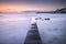 Castiglioncello bay wooden pier, rocks and sea on sunset. Tuscan