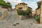 CASTIGLIONE DELLA PESCAIA, ITALY - SEPTEMBER 30, 2016: Y-crossing on narrow streets in steep hill with houses full of flowers