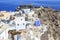 Castillo area with castle and byzantine ruins and greek flag in oia