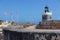 CASTILLO DE SAN FELIPE DEL MORRO, PUERTO RICO, USA - FEB 16, 2015: Lighthouse Tower and stone walkway at fortress lined with flags