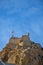 The Castillo de Santa BÃ¡rbara in Alicante on a rocky mountain under a clear blue sky