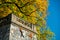 Castle balcony with yellow autumn fall tree