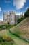 castle built of rock with a huge garden of plants and vegetation in front, sunny day with few clouds