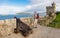 A castle in Galicia on the Atlantic Ocean with a tower, cannon and a hiker.