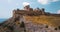 Castle or Genoese fortress on top of the mountain. 4k drone flight. Aerial establisher. Film vintage colors. Great wall