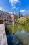 Castle Het Oude Loo reflected in the water surface of its moat, wooden bridge leading to the gate