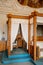 Castle interior bedroom, Secession art nouveau style, wood carved white canopy bed, sofa and stucco on the ceiling, renaissance