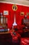 Castle interior. Men`s salon, used as a smoking room for gentlemen. Red room with wooden antique secretary, soft armchairs and