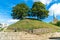 Castle Mound with dual tree and clear blue sky on the top of the hill in Oxford, UK