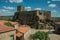 Castle and old houses encircling square with pillory