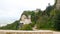 Castle of Pepoli at the top of the mountain, on the rocky cliff, with panoramic view, surrounded by green bushes and trees full o