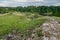 Castle ruins abandoned in the infinite beauty of the expansive green with river view.