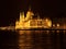 Castle with several towers and domes on Danube Bank Budapest Hungary at night