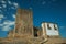 Castle and square tower over rocky hill