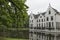 Castle Staverden reflecting in the moat and surrounded by trees