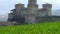 Castle of Torrechiara in Parma, Italy through windy meadow grass panorama - Emilia Romagna region vertical panning