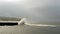 Castlerock Northern Ireland. Beautiful ocean wave breaking on the wharf and the lighthouse