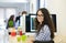 Casual caucasian businesswoman at business startup office with computer, wearing glasses.