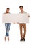 Casual couple posing holding a blank billboard