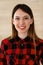 Casual dressed business woman headshot in home office. Young asian entrepreneur or student girl standing and smiling at