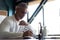 Casual Grey-haired businessman looking through paper documents. Male accounting manager reviewing financial report