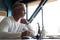 Casual Grey-haired businessman looking through paper documents. Male accounting manager reviewing financial report