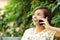 Casual happy woman on the phone in a park