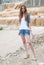 Casual lady, a river after strong rain as background