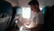 Casual Man Opens Laptop and Works during Airplane Flight Sitting by Window