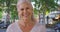 Casual portrait of lovely mature Caucasian woman on Paris street