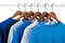 Casual shirts on hangers, different tones of blue